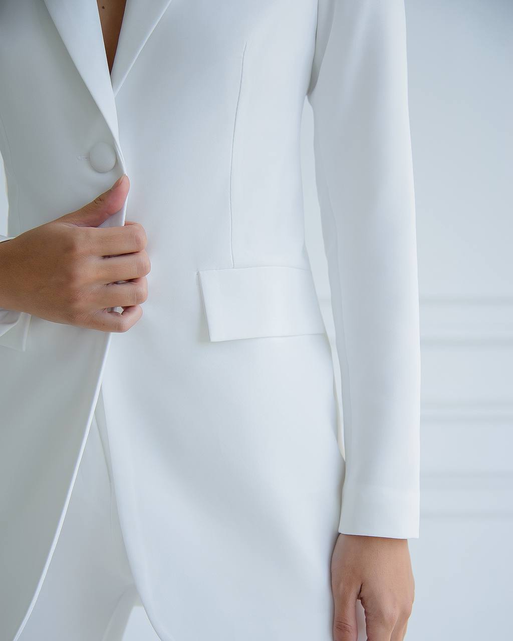 Close-up of a white suit jacket with a blurred background