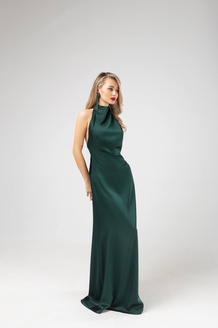 Woman wearing a green evening gown on a white background