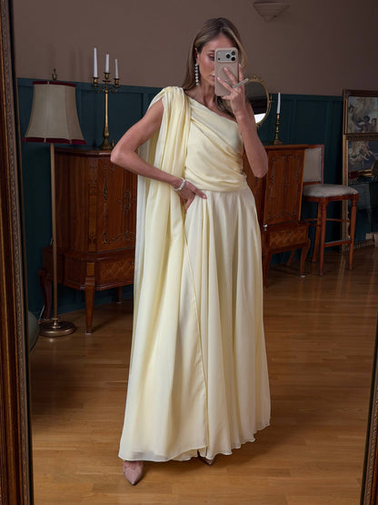 Woman in a white saree taking a mirror selfie in a room with wooden furniture and decor.