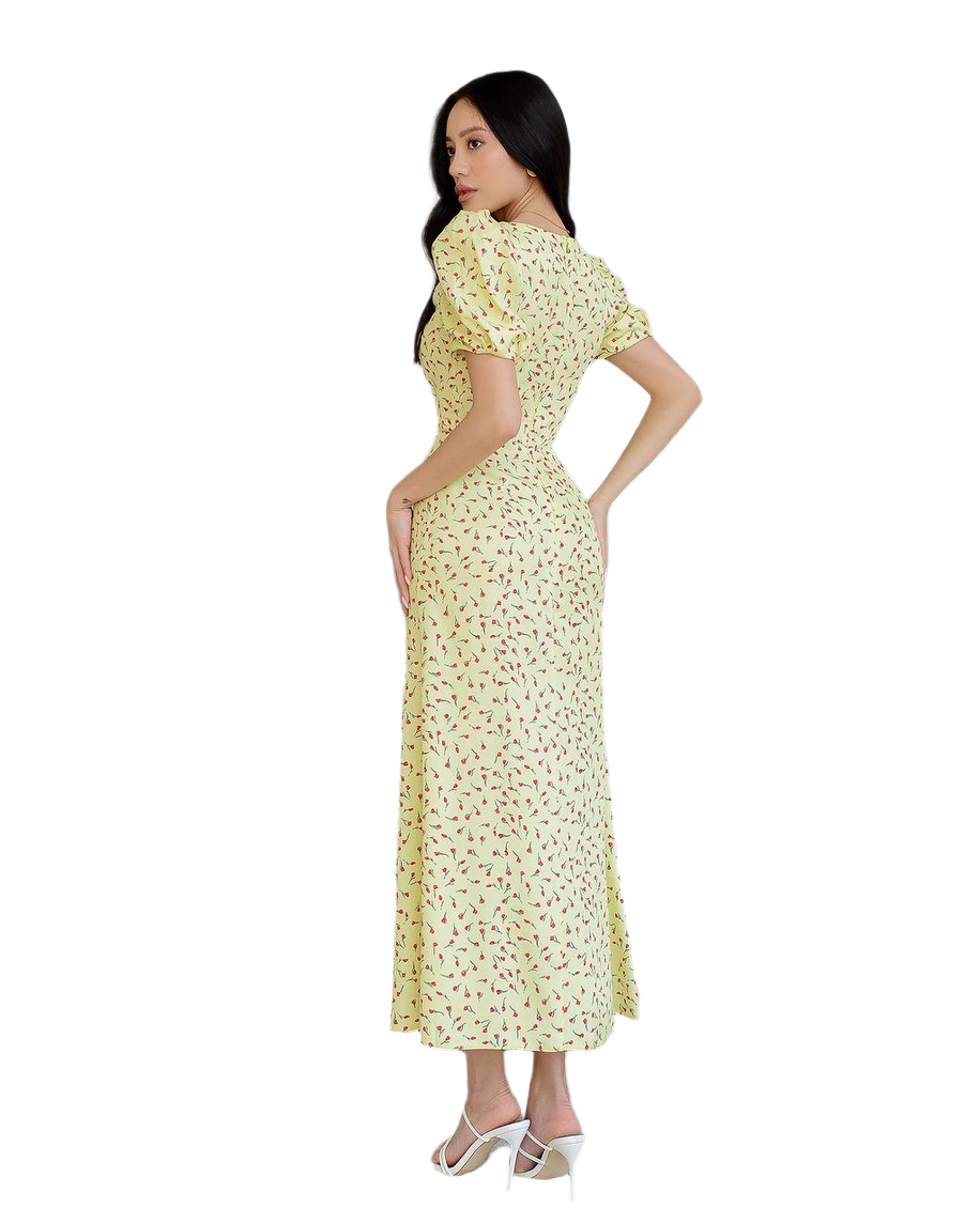 Woman wearing a yellow floral dress on a white background
