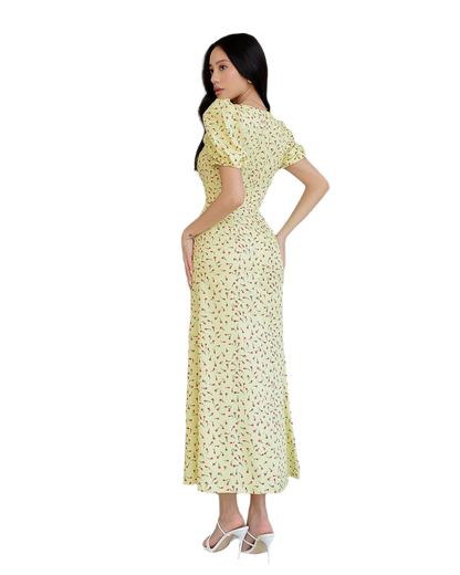 Woman wearing a yellow floral dress on a white background
