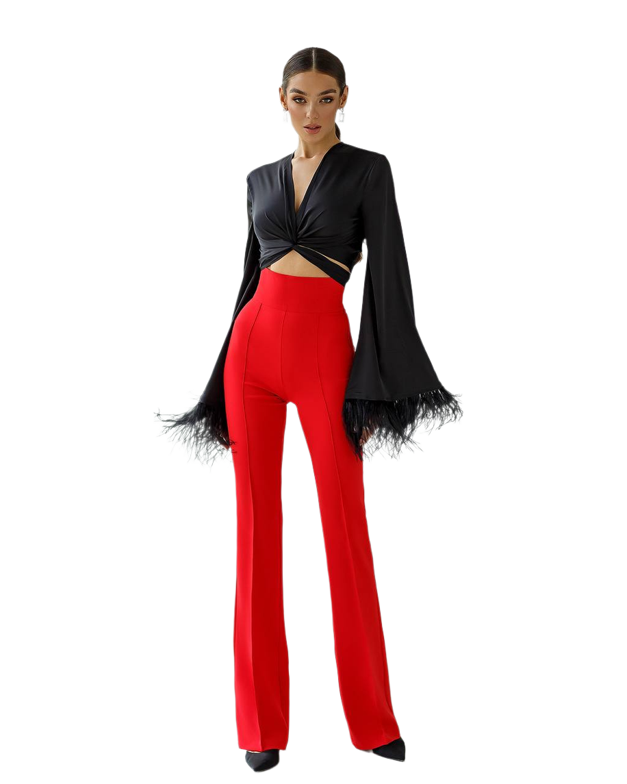 Woman wearing a black top and red pants on a white background