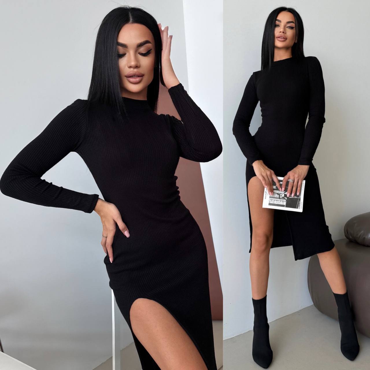 Woman wearing a black long-sleeve dress with a slit, posing indoors.