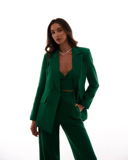 Woman wearing a green suit on a white background