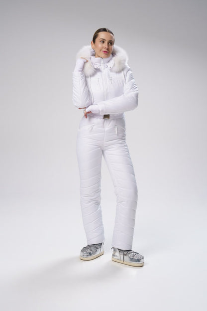 Person wearing a white snowsuit with fur-lined hood on a light gray background