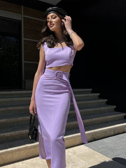 Woman in a lavender outfit standing on steps outdoors