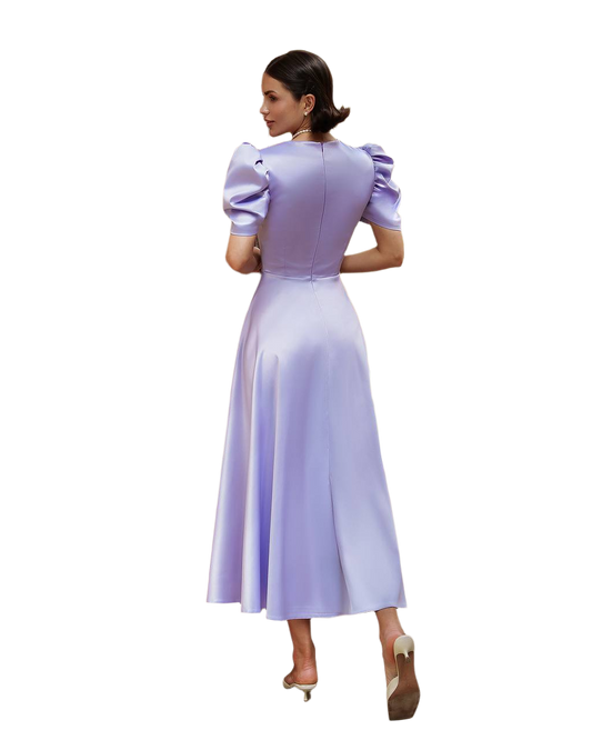 Woman wearing a light purple dress with puffed sleeves on a white background