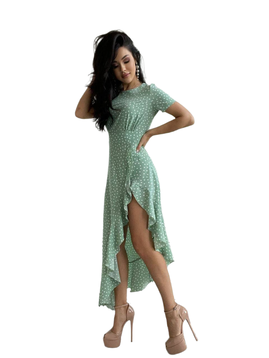 Woman wearing a green polka dot dress on a white background
