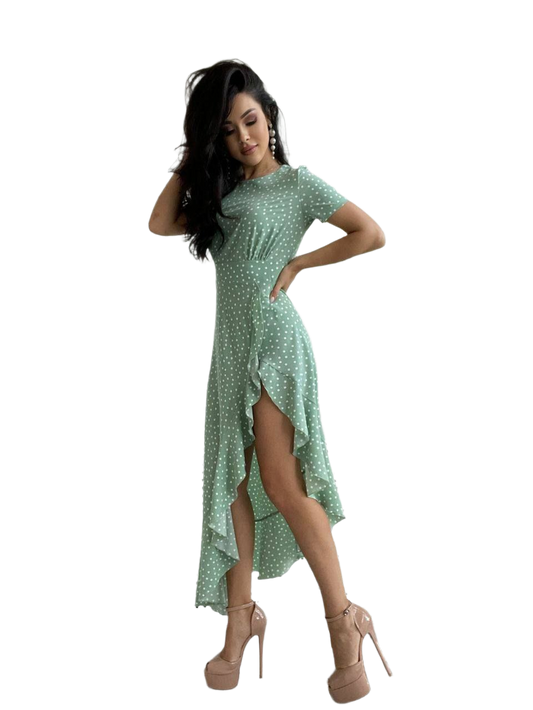 Woman wearing a green polka dot dress on a white background