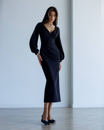 Woman wearing a black dress in a minimalistic setting