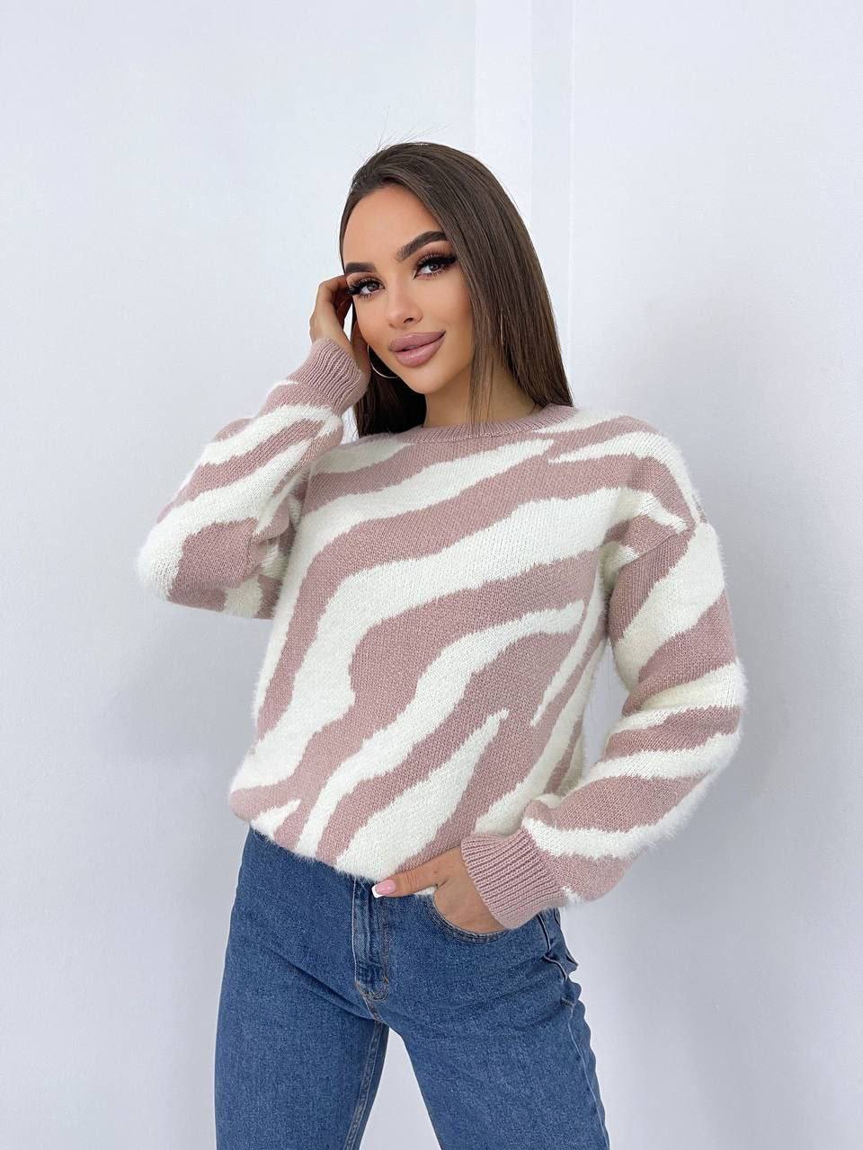 Woman wearing a zebra-striped sweater against a white background