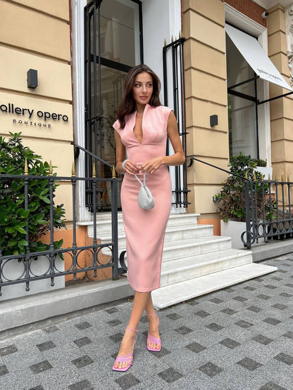 Woman in a pink dress standing outside a building with 'Gallery Opera' sign.