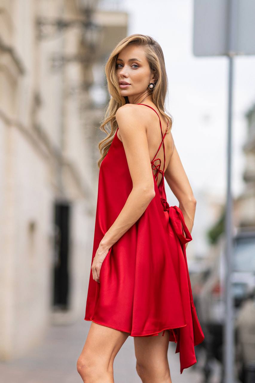 Woman wearing a red dress on a city street
