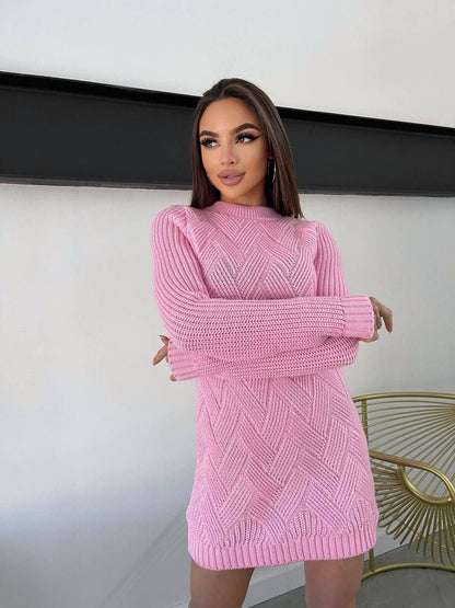 Woman wearing a pink knitted dress against a neutral background