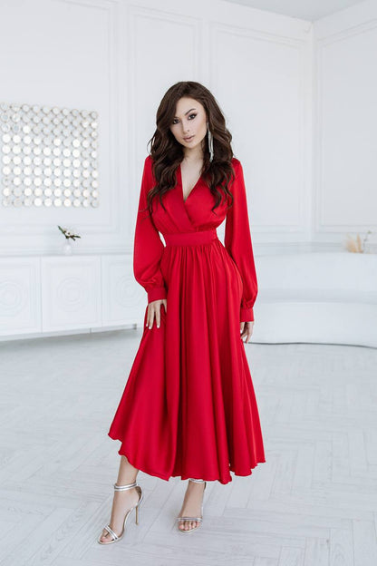 Woman wearing a red dress in a white room
