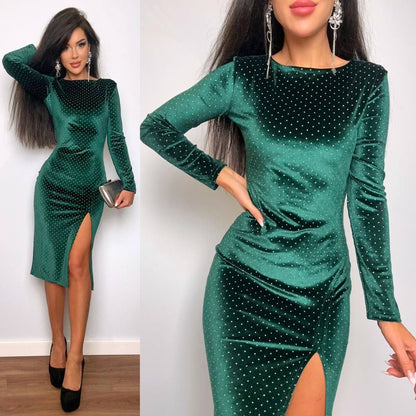 Green dress with long sleeves and a slit on a plain background
