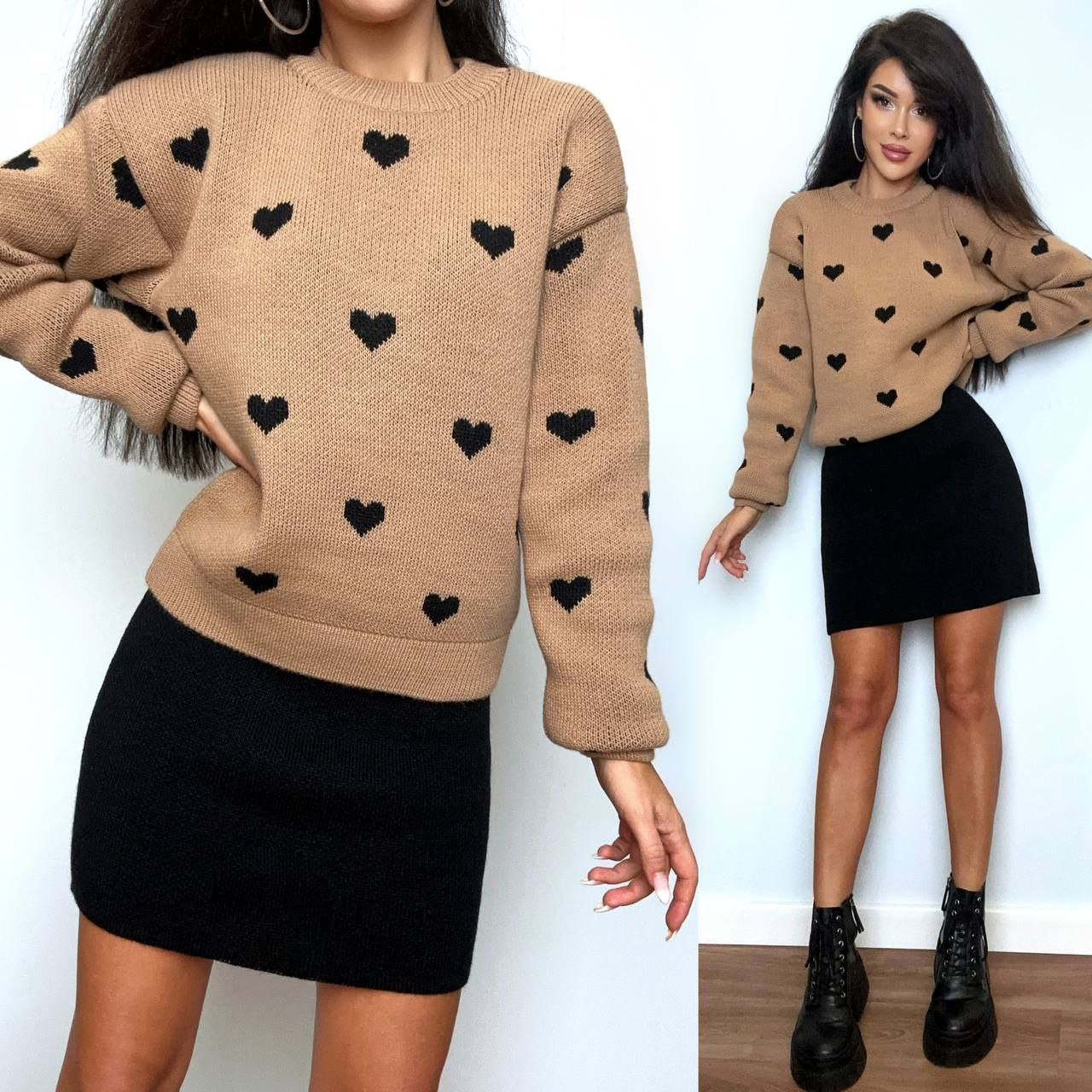 Woman wearing a beige sweater with black heart patterns and a black skirt.