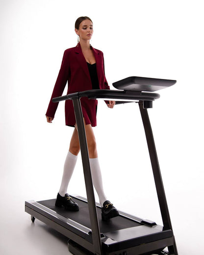 Woman using a treadmill with a white background