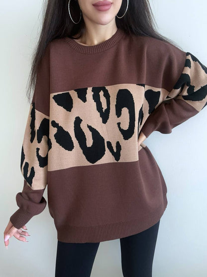 Brown sweater with leopard print pattern worn by a person against a white background