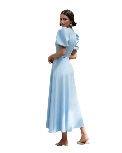 Woman wearing a light blue dress on a white background