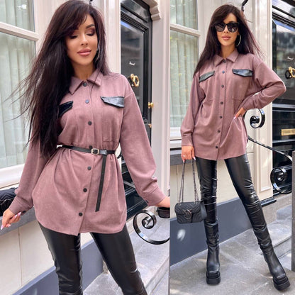 Woman wearing a pink shirt dress with black accents and black leather pants in an urban setting.