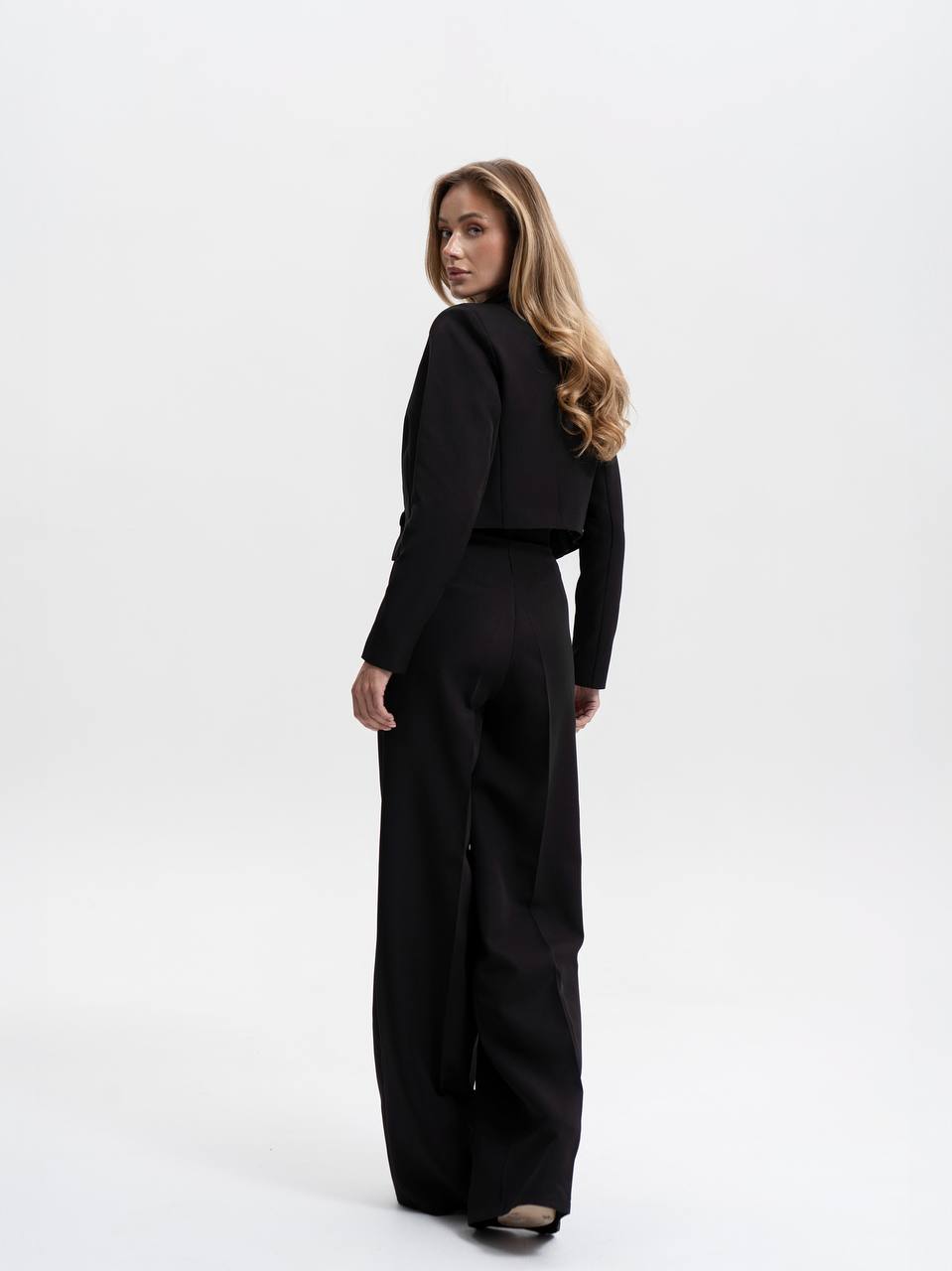Woman wearing a black outfit on a white background