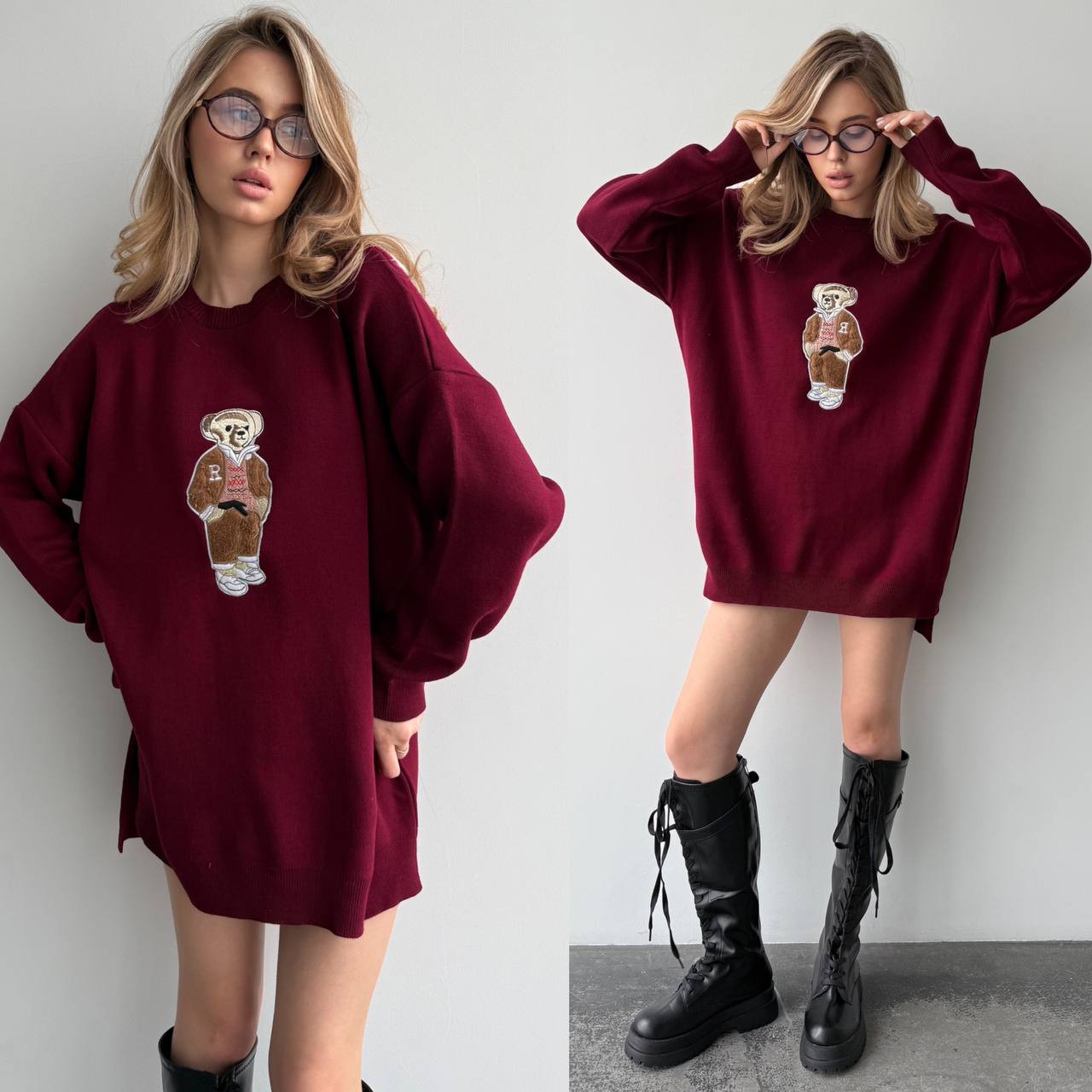 Woman wearing a burgundy sweater with a bear design and black boots on a plain background