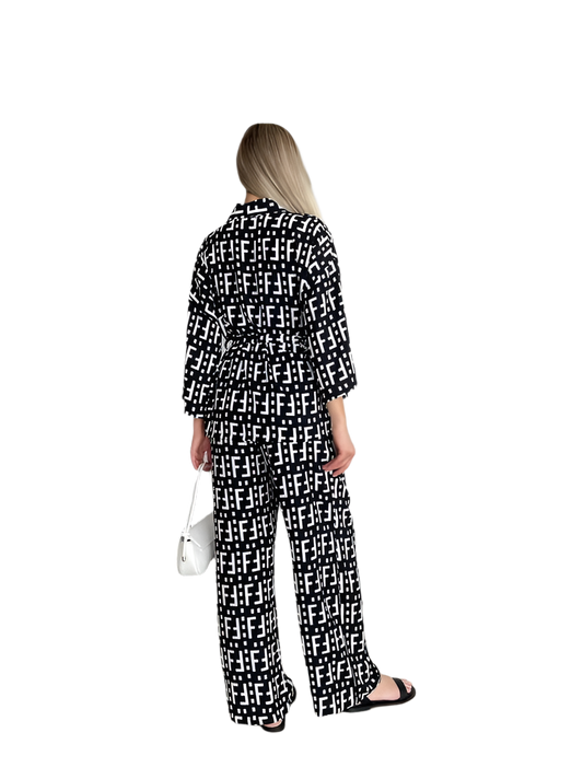 Woman wearing a black and white patterned outfit on a white background