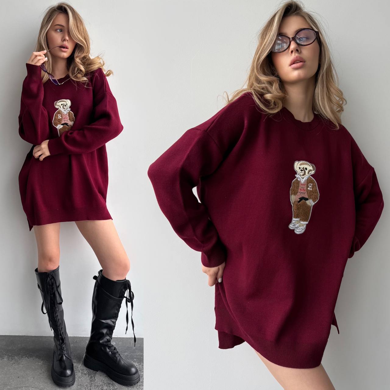 Woman wearing a burgundy sweater dress with a teddy bear patch, standing against a plain background.