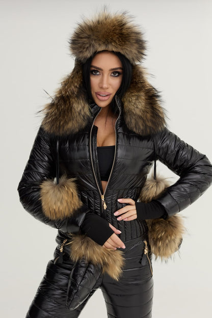 Person wearing a black leather jacket with fur trim on a plain background