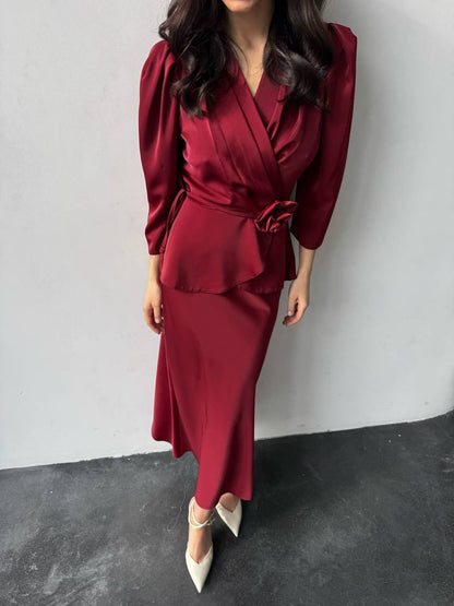 Person wearing a burgundy outfit with a white background
