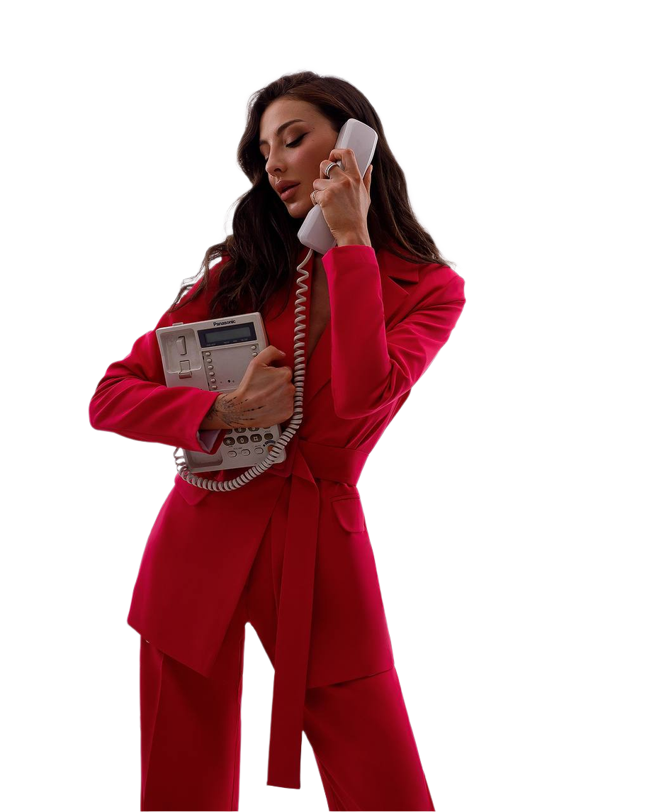 Woman in a red suit holding an old-fashioned telephone on a white background