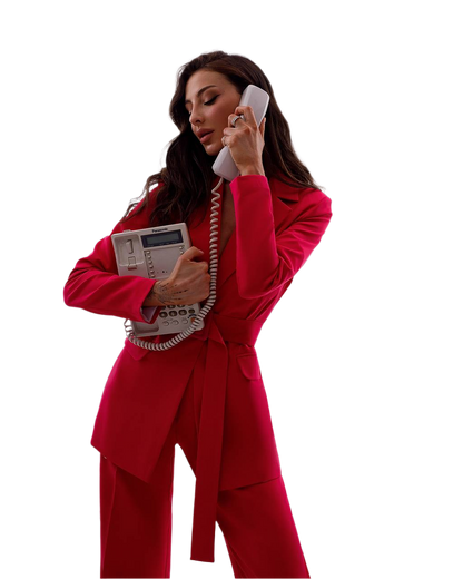 Woman in a red suit holding an old-fashioned telephone on a white background