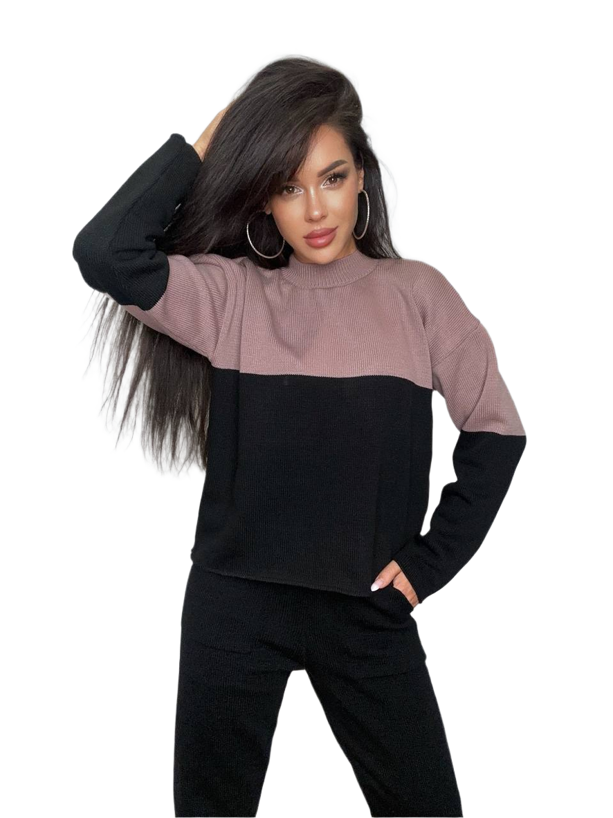 Woman wearing a two-tone black and pink sweater on a white background