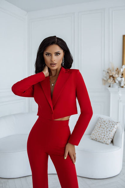 Woman wearing a red outfit in a white room