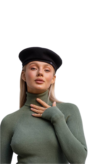 Woman wearing a green turtleneck sweater and black beret on a white background
