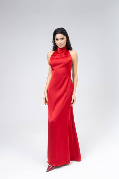 Woman wearing a red halter neck gown on a white background