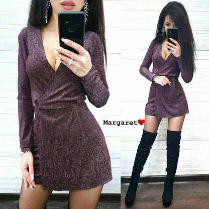 Woman wearing a sparkly purple dress and black knee-high boots, taking a mirror selfie.