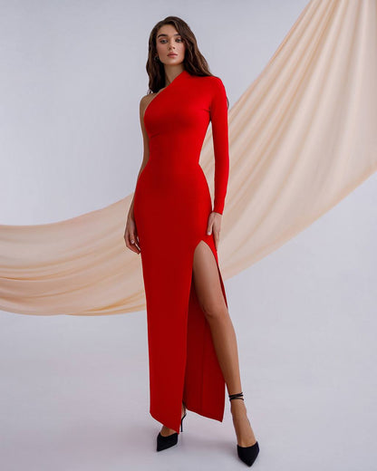 Woman wearing a red one-shoulder dress with a slit, standing against a plain background.