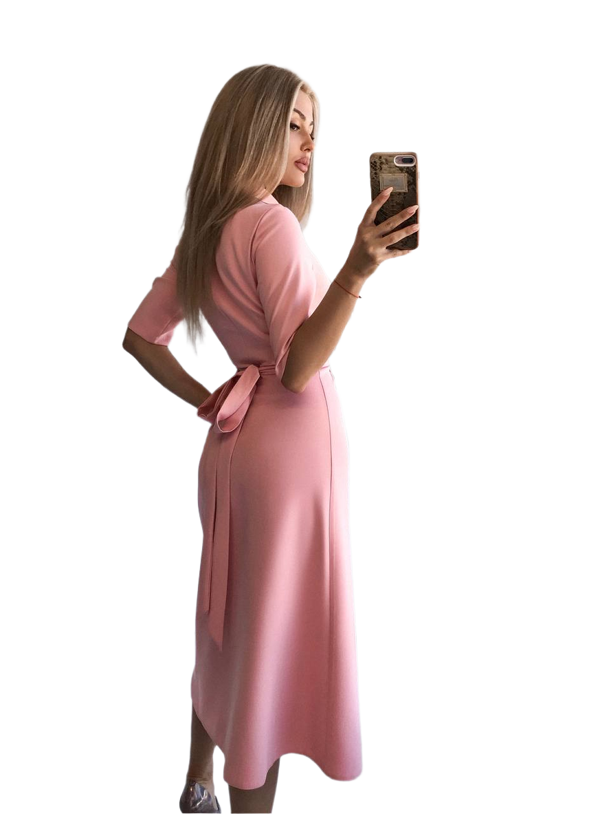 Woman in a pink dress taking a selfie on a white background