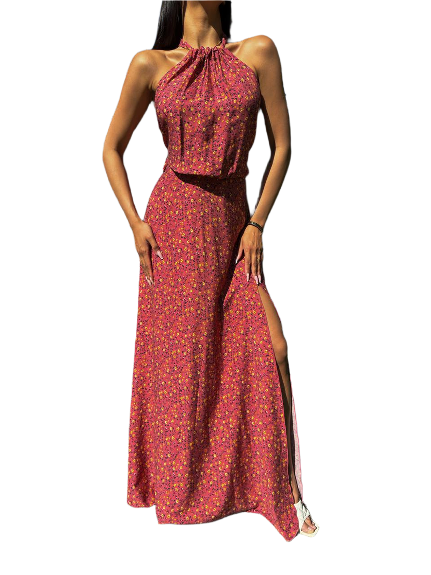 Woman wearing a red floral dress with a slit on a white background