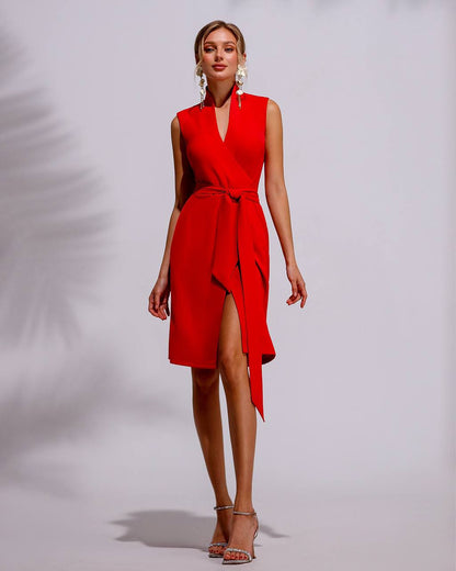 Red sleeveless dress with a belt and slit on a plain background