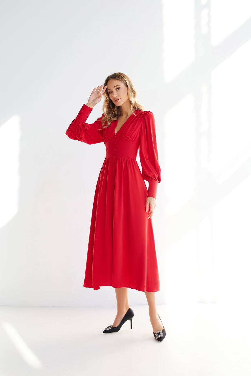Woman wearing a red dress against a white background