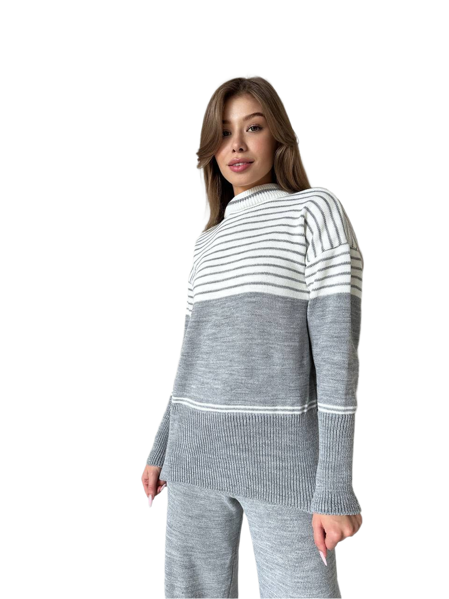 Woman wearing a gray and white striped sweater on a white background