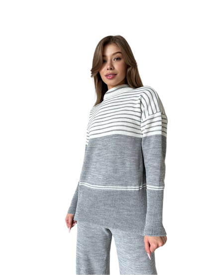 Woman wearing a gray and white striped sweater on a white background