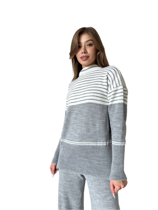 Woman wearing a gray and white striped sweater on a white background