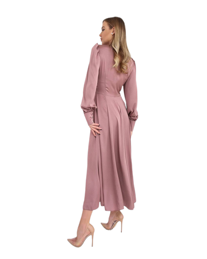 Woman wearing a pink dress on a white background