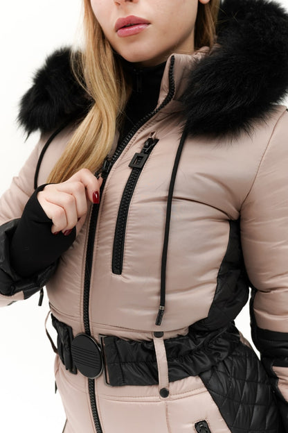 Person wearing a beige winter coat with black fur hood on a white background