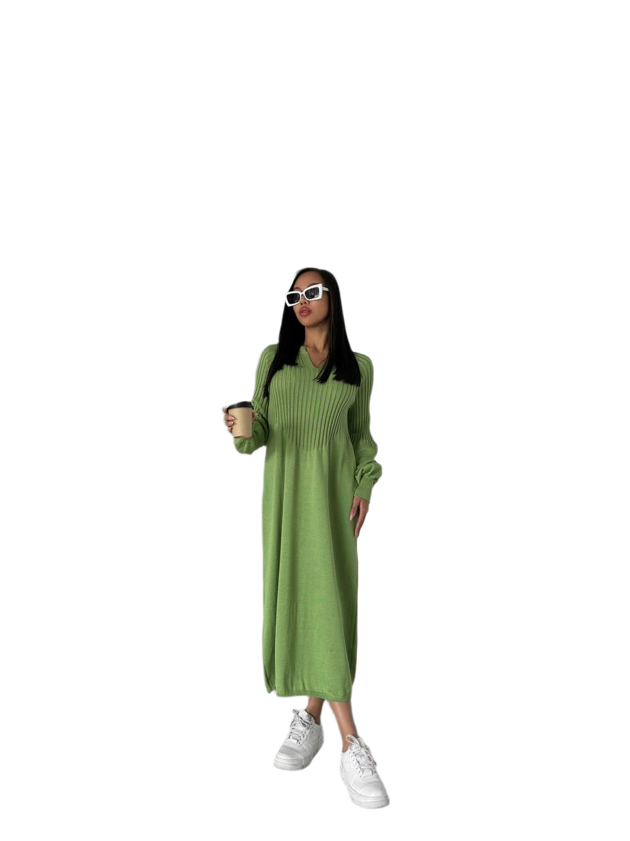 Woman wearing a green dress and white sneakers on a white background