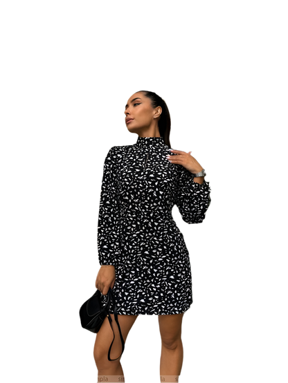 Woman wearing a black and white patterned dress on a white background